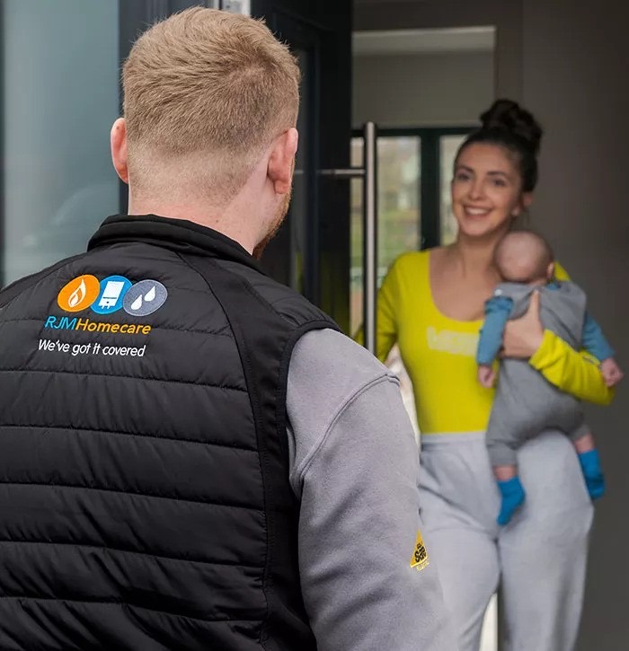 Engineer chatting with a mum holding her baby